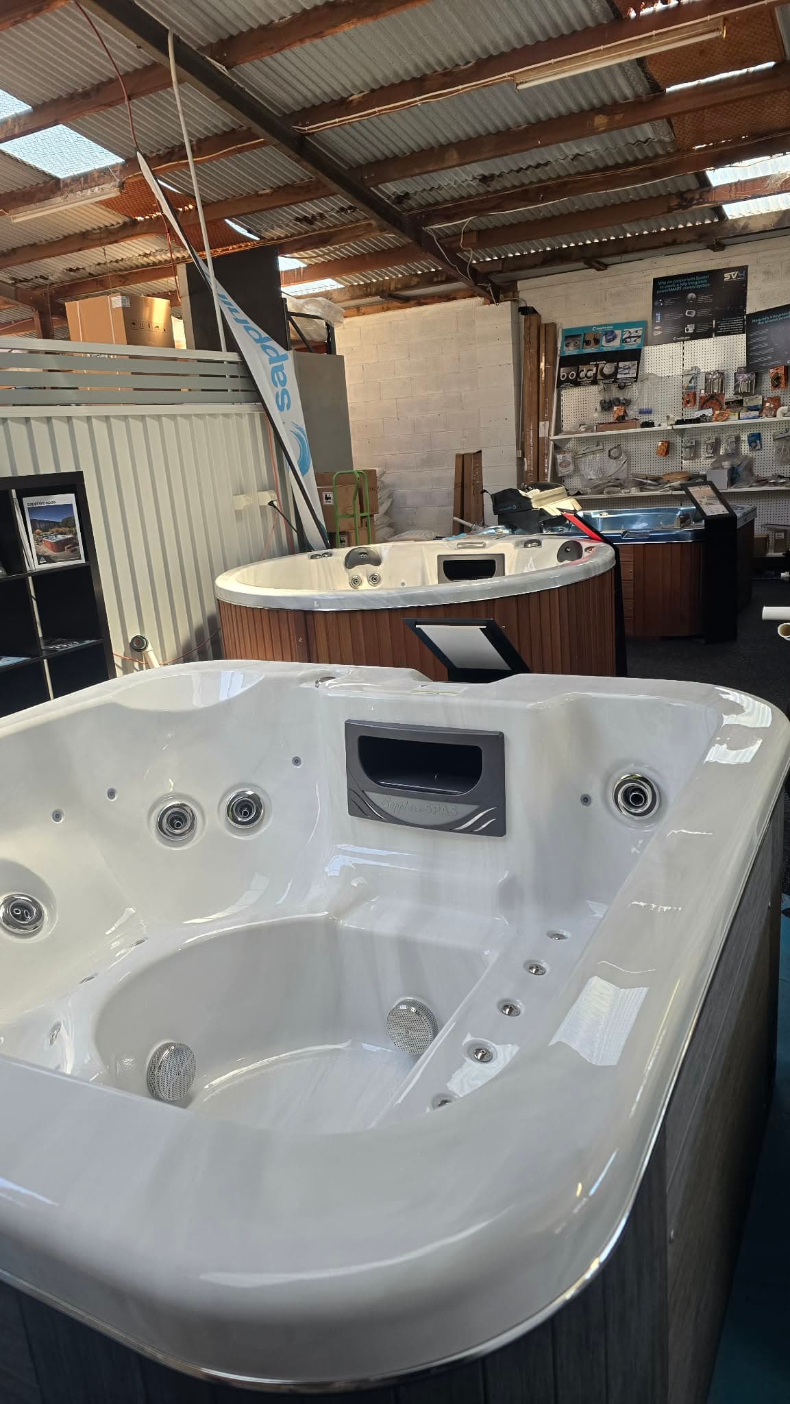Close-up of a white display spa in the Cowes showroom