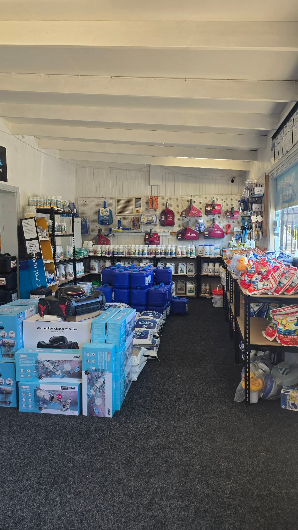 Shelves stocked with pool and spa products in the showroom